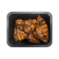Grilled chicken pieces on a black tray