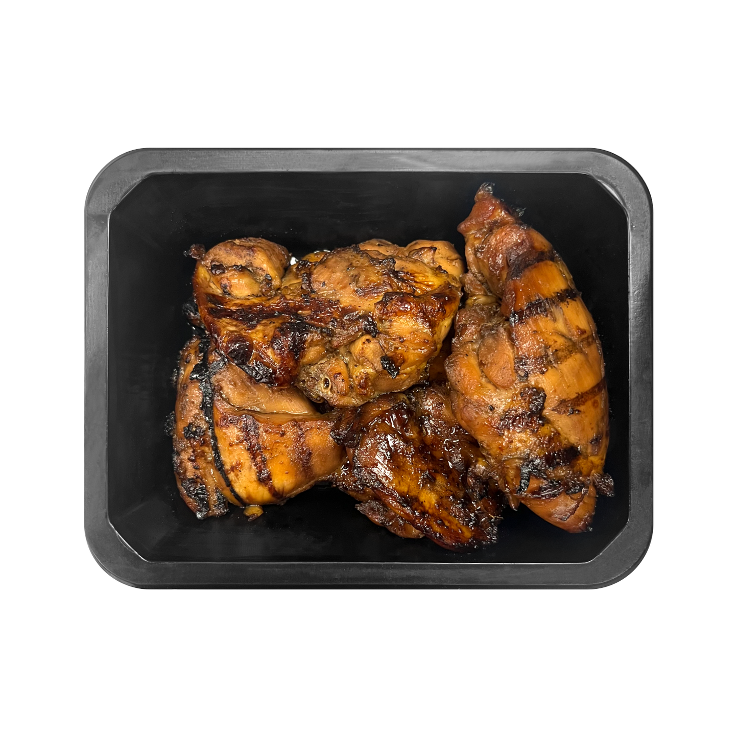 Grilled chicken pieces on a black tray